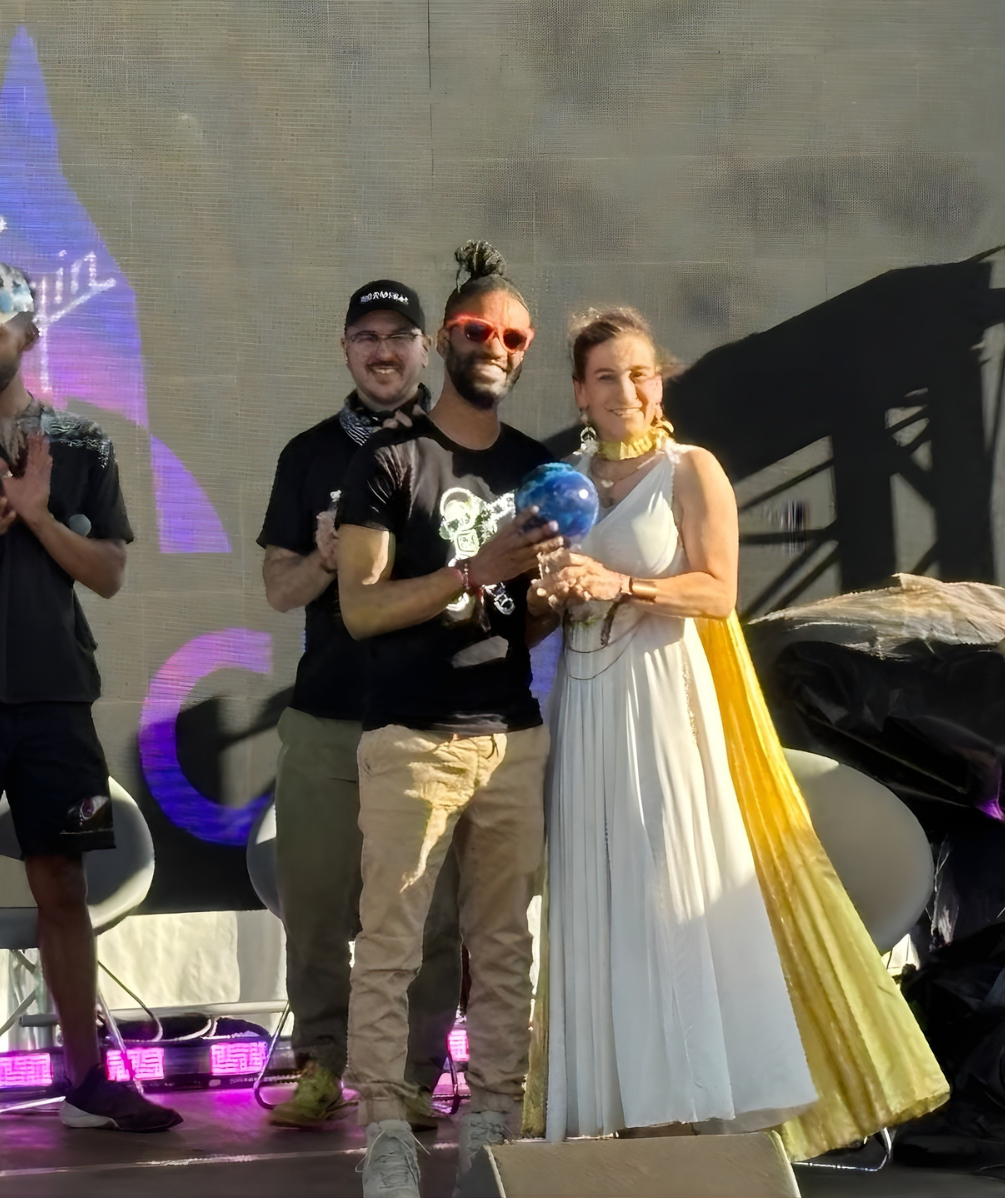 Chris Huie winning Spirit of Yuri's Night Award on Behalf of VG 2023 at Eclipse fest